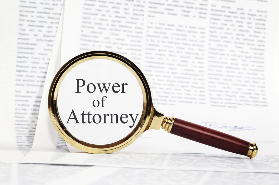 A magnifying glass showing the words 'Power of Attorney'